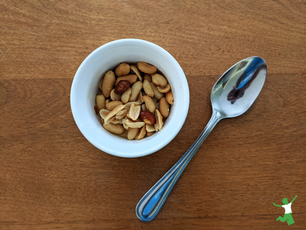 healthy honey roasted peanuts in a white ramekin