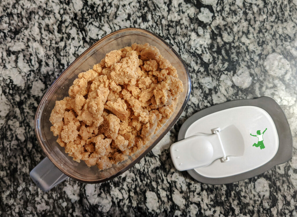 homemade peanut butter cereal in a container on granite table