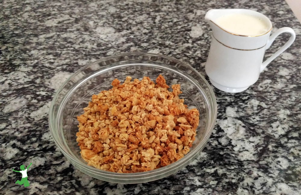 homemade breakfast cereal on granite table with milk