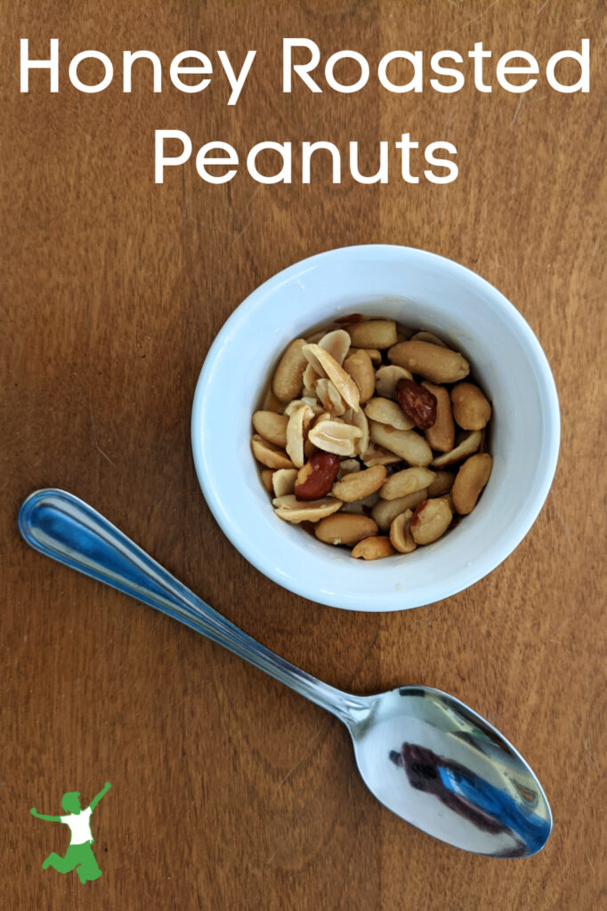 healthy honey roasted peanuts in bowl with spoon