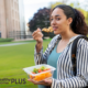 college student eating healthy food from glass container