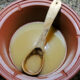 homemade broth with glutamate in clay stockpot with wooden ladle
