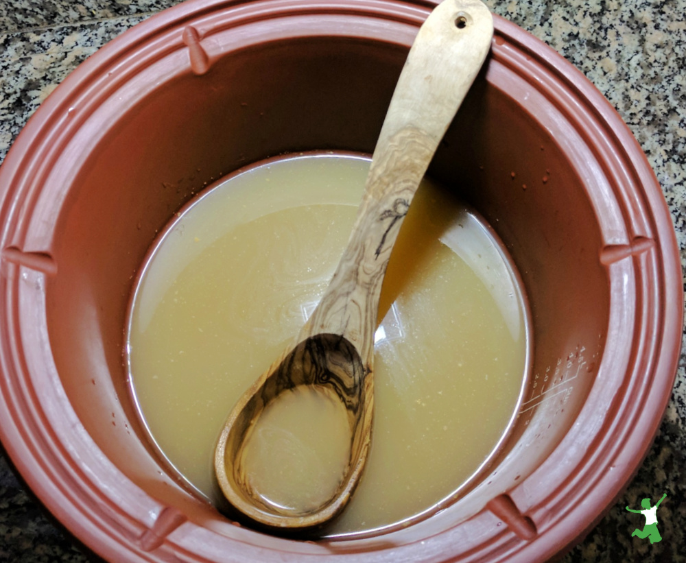 bone broth with MSG in clay pot with bamboo ladle