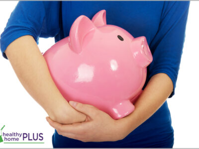 woman holding large piggy bank of savings on traditional foods