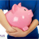 woman holding large piggy bank of savings on traditional foods