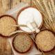 GMO wheat and hybrid varieties in bowls on wooden table