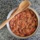 cajun sausage skillet on counter with wooden spoon