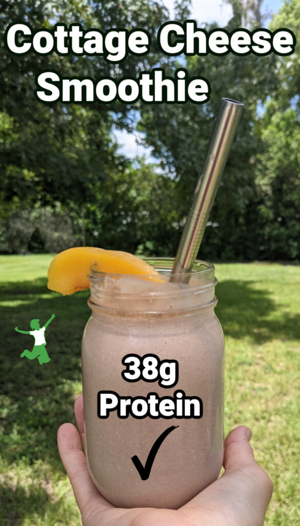 woman holding cottage cheese smoothie in pint mason jar with straw