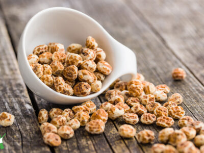 tiger nuts, earth almonds, chufas in white bowl on wooden table