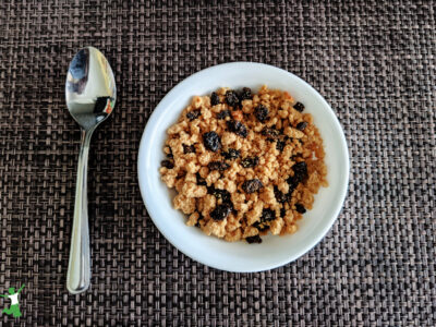 homemade raisin bran in white bowl with spoon