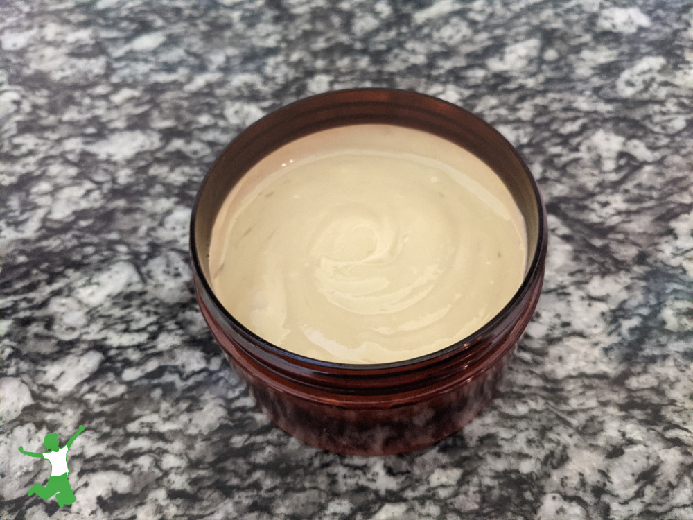 homemade vanilla body lotion in amber jar on granite counter