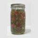 mason jar of chelating cilantro salsa on white background