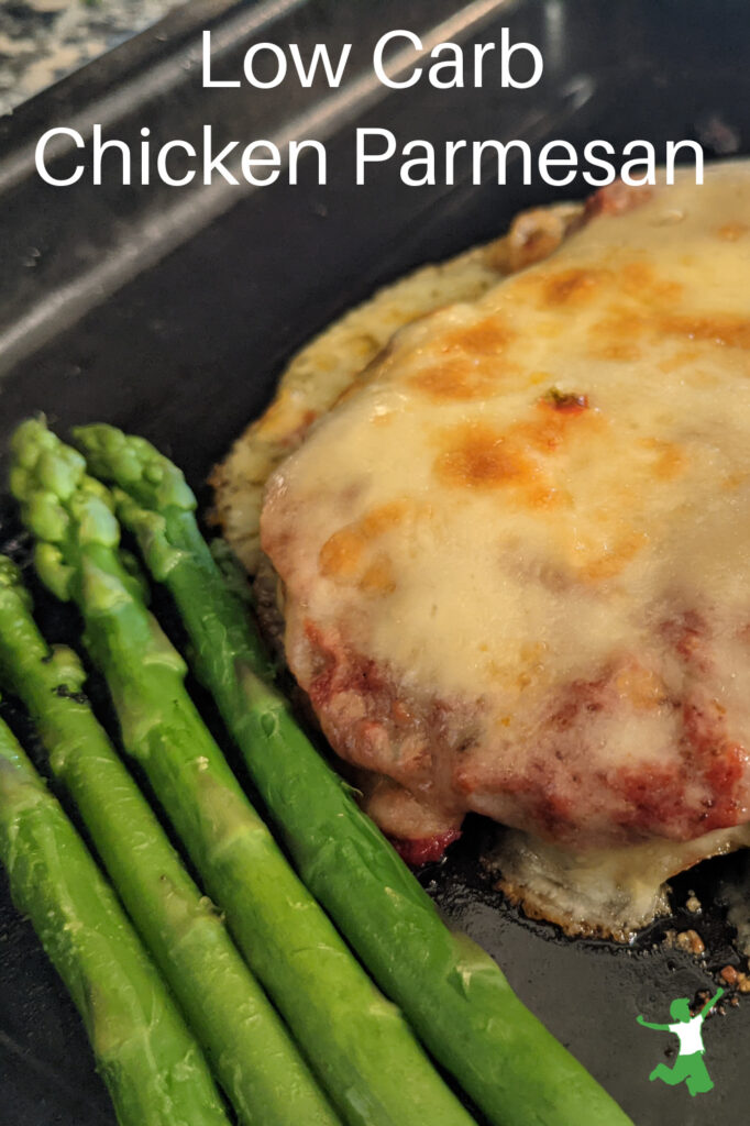 low carb chicken parmesan with grain-free breading and asparagus in baking pan