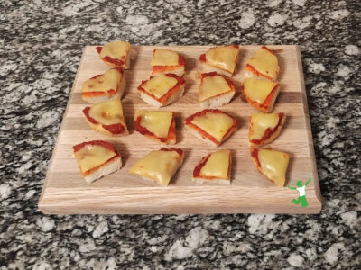 healthy, homemade pizza bites arranged on wood