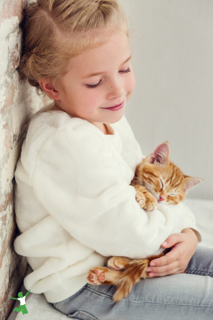 little girl with no allergies holding a pet cat