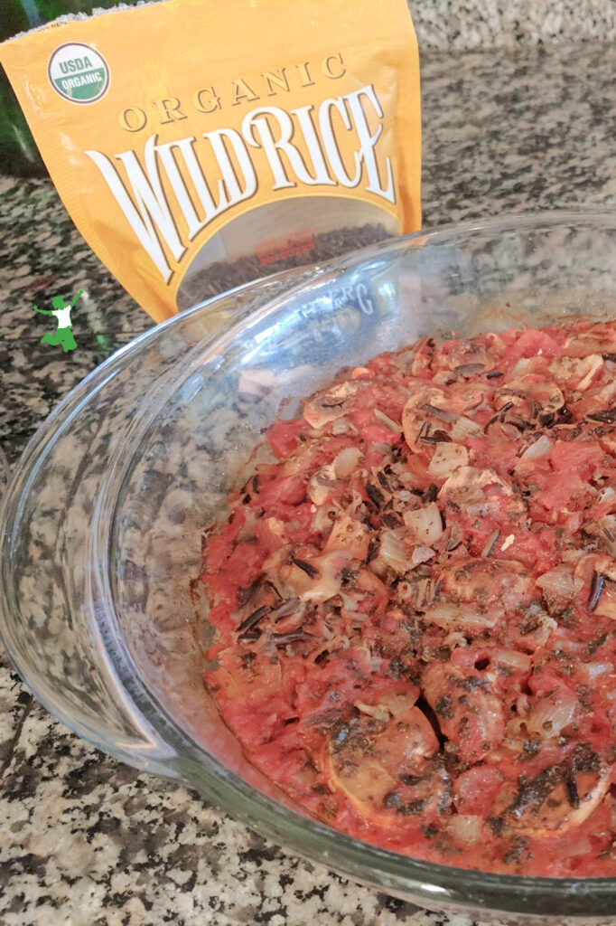 wild rice casserole in glass baking dish on granite counter