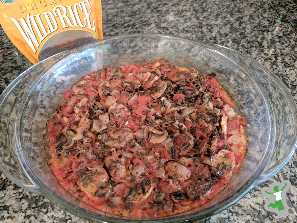 hearty wild rice casserole in a glass baking dish on granite counter