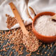 buckwheat groats and flour in clay bowl with white tablecloth