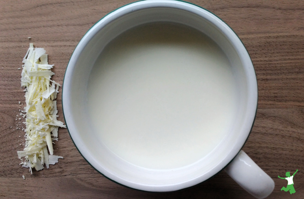 hot white chocolate in a mug wooden background