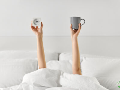 woman drinking coffee in the morning before getting out of bed