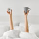 woman drinking coffee in the morning before getting out of bed