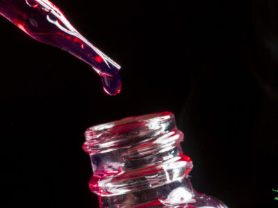 drops of vegetable glycerin from eyedropper into bottle