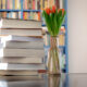 best health books stacked on table with bookshelf in background