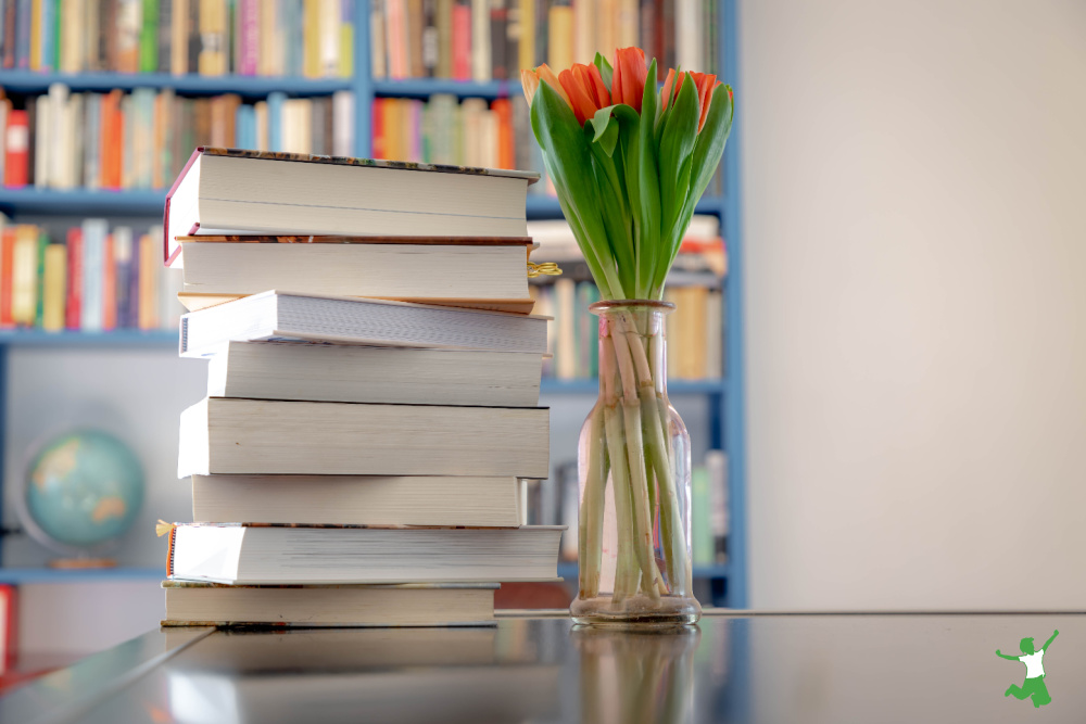 best health books stacked on table with bookshelf in background