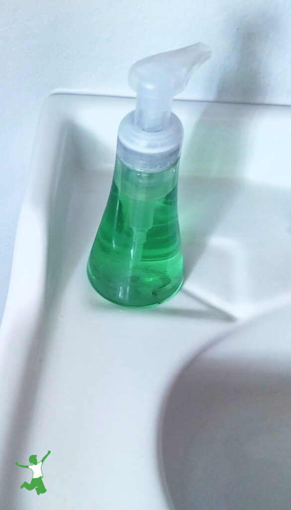 homemade nontoxic liquid hand soap in dispenser on bathroom sink