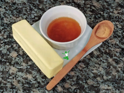 small white bowl of miso brown butter on white plate with two ingredients