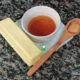 small white bowl of miso brown butter on white plate with two ingredients