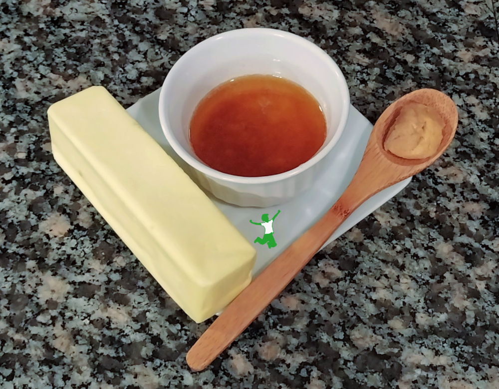 small white bowl of miso brown butter on white plate with two ingredients