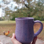 stinging nettle latte in a lavendar mug with natural background