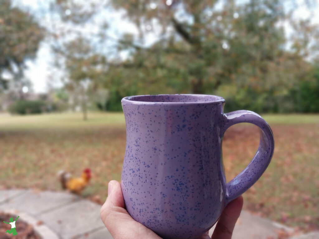 stinging nettle latte in a lavendar mug with natural background