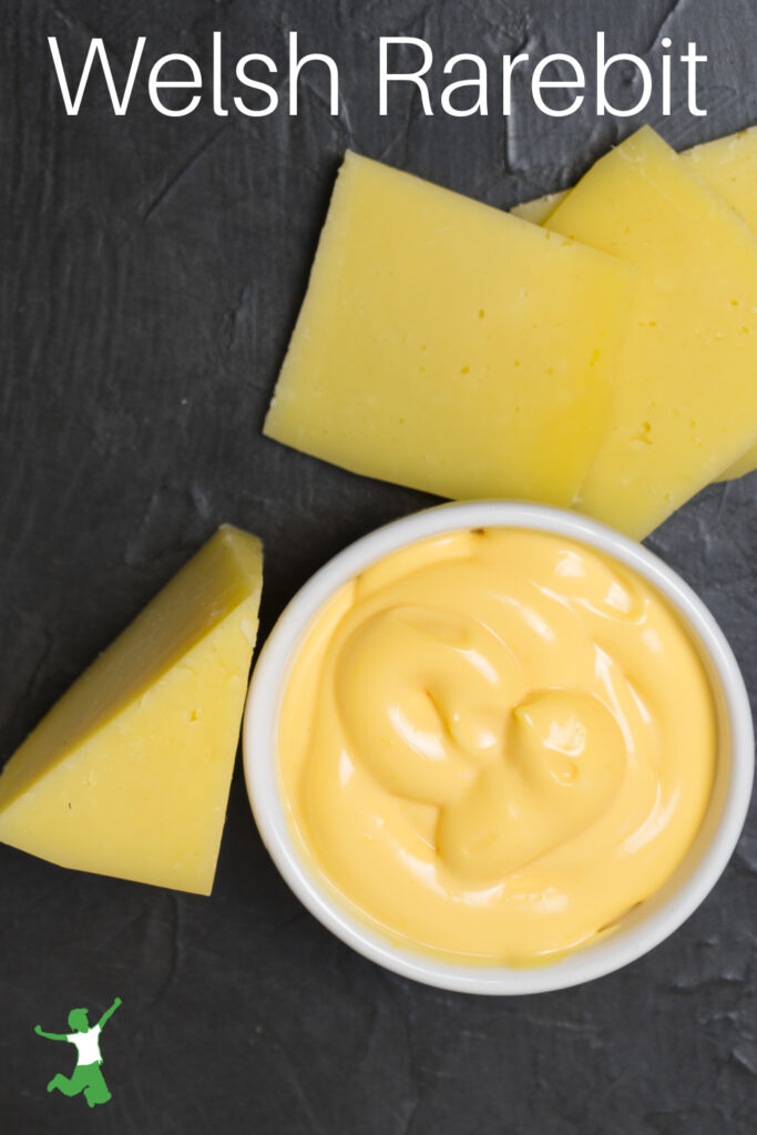 traditional Welsh rarebit in white bowl with cheddar cheese slices