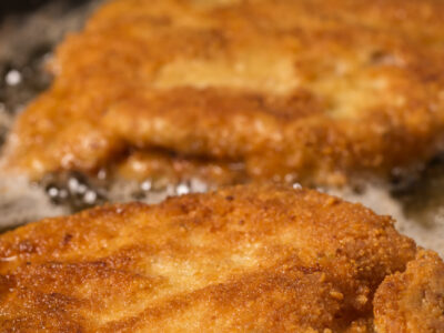 beef heart organ meat cutlets frying in a pan