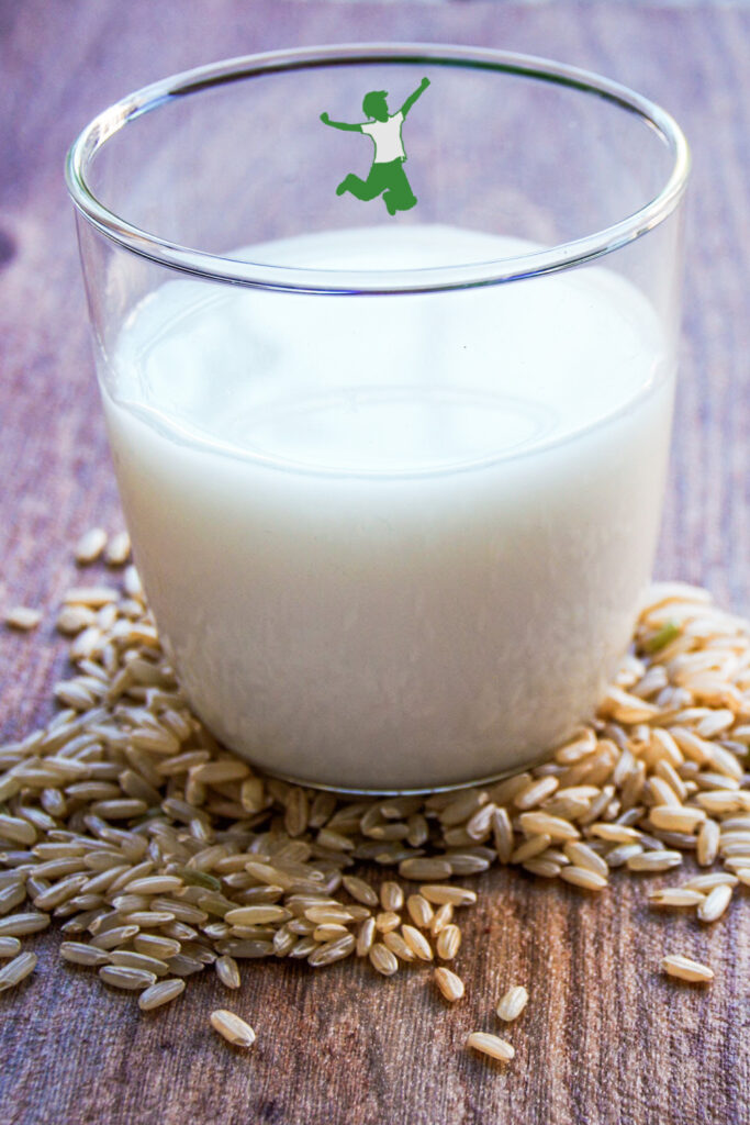 cultured brown rice milk in glass on wood table