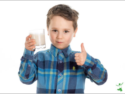 young boy drinking healthy milk substitute in a glass