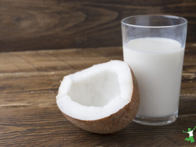 homemade and healthy coconut milk tonic beverage in a glass on wooden table