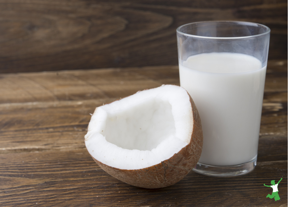 homemade and healthy coconut milk tonic beverage in a glass on wooden table