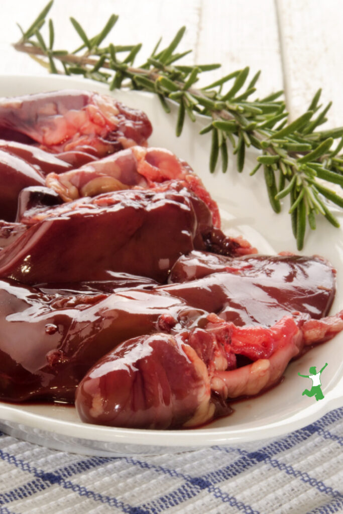 turkey giblets on white plate with rosemary sprig