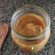 fermented mango butter in mason jar with wooden spoon