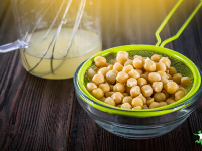 aquafaba strained into glass bowl using chickpea water sieve