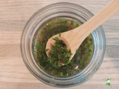 traditional mint sauce for lamb or mutton in glass jar with bamboo spoon