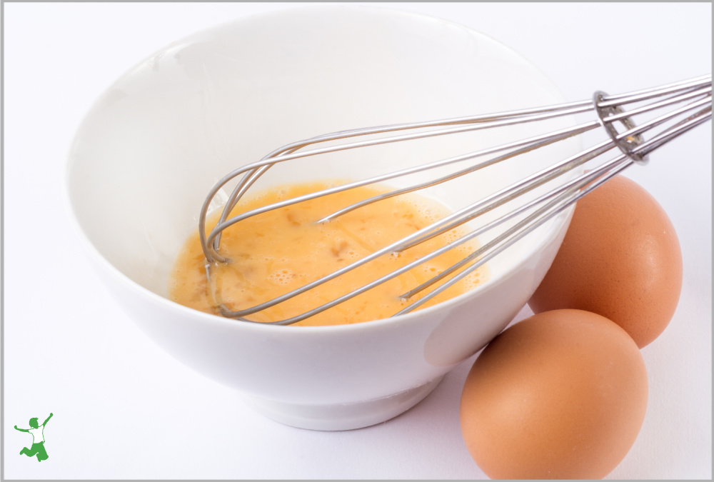 egg yolks to make Russian custard in a white bowl