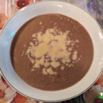 soaked refried beans with grated cheese topping