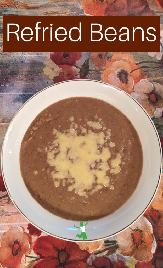 traditional refried beans with cheese in serving bowl