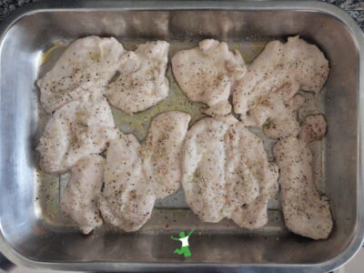 lemon pepper chicken cutlets in baking pan