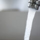 fluoridated water running from kitchen faucet