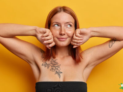 young woman with tattoos on chest and left arm